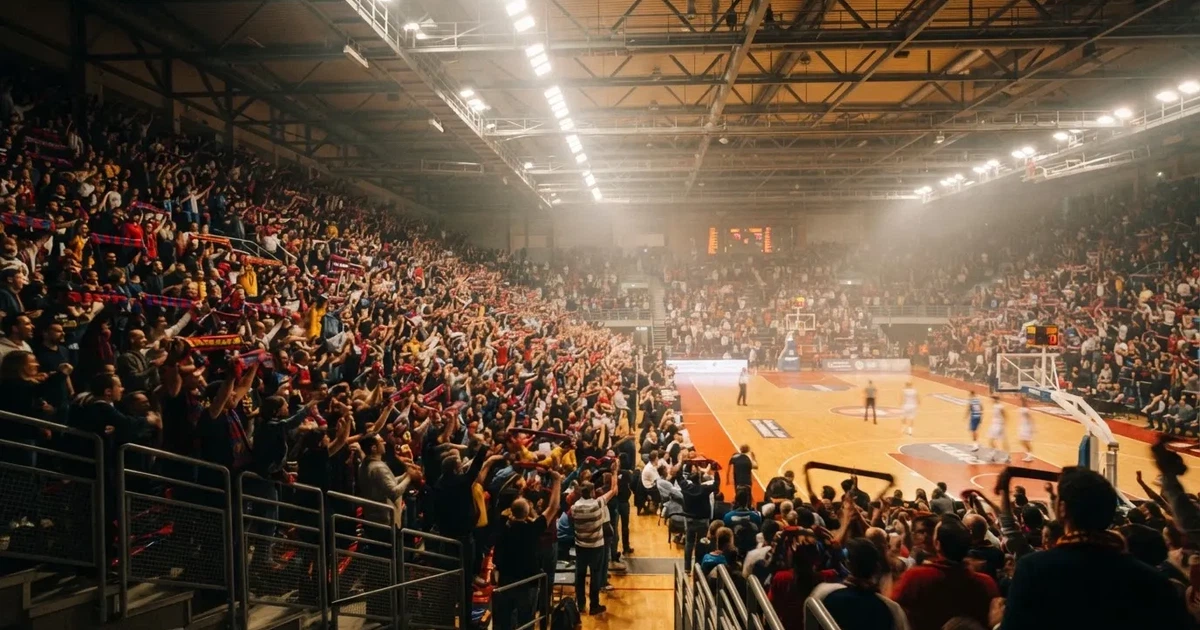 Un pabellón deportivo lleno bajo los focos, fotografiado desde muy lejos